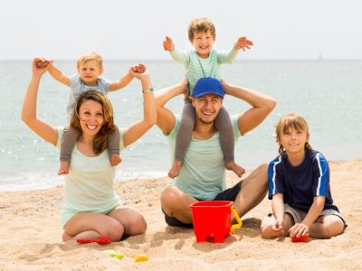 Happy family of five smiling at sea beach Happy family of five smiling at sea beach and resting together